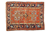 Vintage Karaja rug with madder red field, navy borders, geometric stepped medallions, mostly even wear.