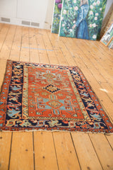 Stepped geometric medallion and classic Karaja border on a madder red field.