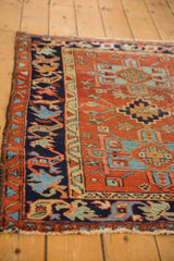 Vintage Karaja rug: navy border, sky blue stylized motifs, geometric red field, and visible wear.