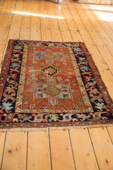 Vintage Karaja rug corner, geometric patterns, secured fringe, and abrashed madder red field.