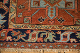 Detail of Karaja rug's madder red field, navy border with floral motifs, and fringe.