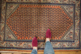Vintage Mir Serbend rug's burnt orange field with navy mir boteh and geometric borders.