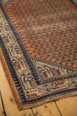 Vintage Mir Serbend rug corner with navy, ivory, and terracotta geometric pawn borders.