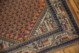 Vintage Mir Serbend rug corner with geometric pawn and vine borders in terracotta, navy, ivory.