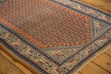 Vintage Mir Serbend rug corner with rust boteh field, navy geometric borders, and visible wear.