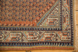 Vintage Mir Serbend rug corner showcasing terracotta field, geometric pawn and vine borders.