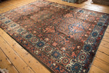 Vintage Baktiari carpet's garden panel motif with lattice outlines and floral ivory border.