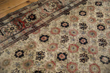 Hard wear across the Herati border and ivory floral field of a vintage Veramin carpet.