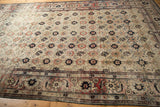 Worn texture on a vintage Veramin carpet showing its floral field and Herati samovar border.