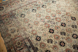 Close view of the worn Herati border and floral field on a vintage distressed Veramin carpet.