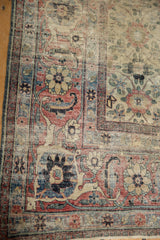 Time-softened tones and decorative wear on the Herati border of a vintage Veramin rug.