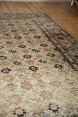 Worn texture of a distressed Persian Veramin carpet with floral and vinery motifs.