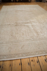 Corner view of distressed Sivas carpet, showing faded floral motifs and even worn pile.
