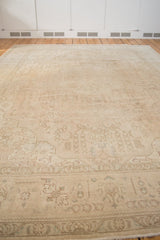 Distressed Sivas rug corner, subtle floral patterns and ivory tones.