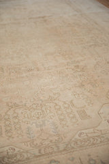 Worn pile and faded curvilinear floral motifs on a distressed vintage Sivas carpet.