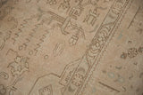 Distressed Sivas rug detail with faded beige geometric patterns and evident wear.