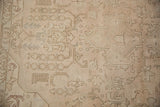Distressed vintage Sivas rug texture featuring faded ivory, sand, and subtle rose hues.