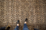 Distressed Malayer carpet's diamond medallion and neutral Herati pattern with soft aqua details.