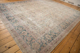 Distressed vintage Turkish Sparta rug corner showcasing curvilinear palmette border and faded tree of life motif.