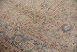Distressed pile texture and faded palmette motifs on a vintage Sparta carpet.