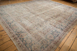 Distressed vintage Sparta carpet showing even wear, faded palmette borders, and softened blush, blue, and red.