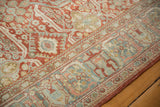 Distressed cherry red field and dusty blue border patterns on vintage Mahal rug.