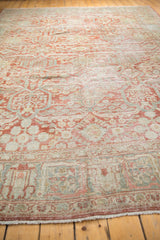 Distressed Mahal carpet border showcasing worn cherry red, dusty blue, and ivory with fringe.