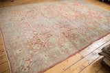 Distressed vintage Mahal rug corner, showing soft red, blue, ivory tones and worn texture.