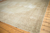 Distressed vintage Tabriz carpet corner with scrolling vinery in ivory and pale coffee brown.