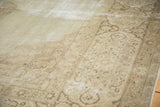 Distressed vintage Tabriz rug border, with faded ivory and coffee brown scrolling vinery.