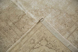 Distressed vintage Tabriz rug's worn pile, muted pattern, and tightly woven foundation.