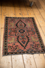 Antique Lilihan rug corner detail, highlighting Manticore motif, dusty raspberry, and tattered end.