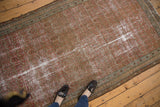 Extensively worn Malayer rug showcasing blush and pale brick red colors with allover boteh.