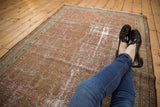Distressed vintage Malayer rug with allover boteh pattern, abrashes, and dusty rose tones.