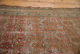 Distressed blush and brick red Malayer rug field with shadow outline boteh pattern and foundation wear.