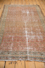 Distressed Malayer rug edge, showing fringe, faded blush tones, and worn boteh motif.