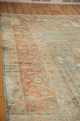 Distressed Lilihan carpet border with terra cotta blossomed vinery on textured beige.