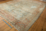 Distressed vintage Lilihan carpet edge, showing white fringe and worn floral border.