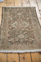 Distressed vintage Karaja rug corner, geometric floral motifs, and intact side selvage.