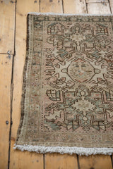 Faded serrated geometric pattern, even wear, and fringe on a vintage 1940s Karaja rug.