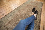 Distressed vintage Karaja runner with geometric pawn motif and elongated plants in soft teal.