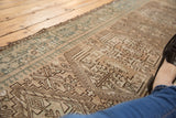 Distressed vintage Karaja runner with geometric pawn motifs in beige, brown, and dusty teal.