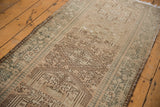 Distressed vintage Karaja runner, with geometric pawn motif and beige, brown, teal tones.