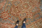 Distressed vintage Karaja carpet's geometric pattern with sky blue, dusty blush, and wine red.