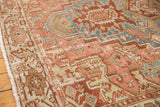 Distressed Karaja rug border with geometric patterns in sky blue, dusty rose, and green tones.
