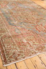 Distressed Karaja rug corner with worn geometric pattern, fringe, and time-softened blush, sky blue.