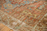Distressed Karaja carpet corner detail, showing fringe and pale green geometric border.