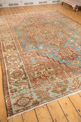 Distressed Karaja carpet corner, showing geometric relief in sky blue, blush rose, and visible wear.