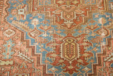 Distressed Karaja rug detail shows geometric patterns, sky blue, blush rose, and worn pile.