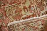 Distressed Karaja carpet edge with fringe, showcasing geometric patterns and aged texture.